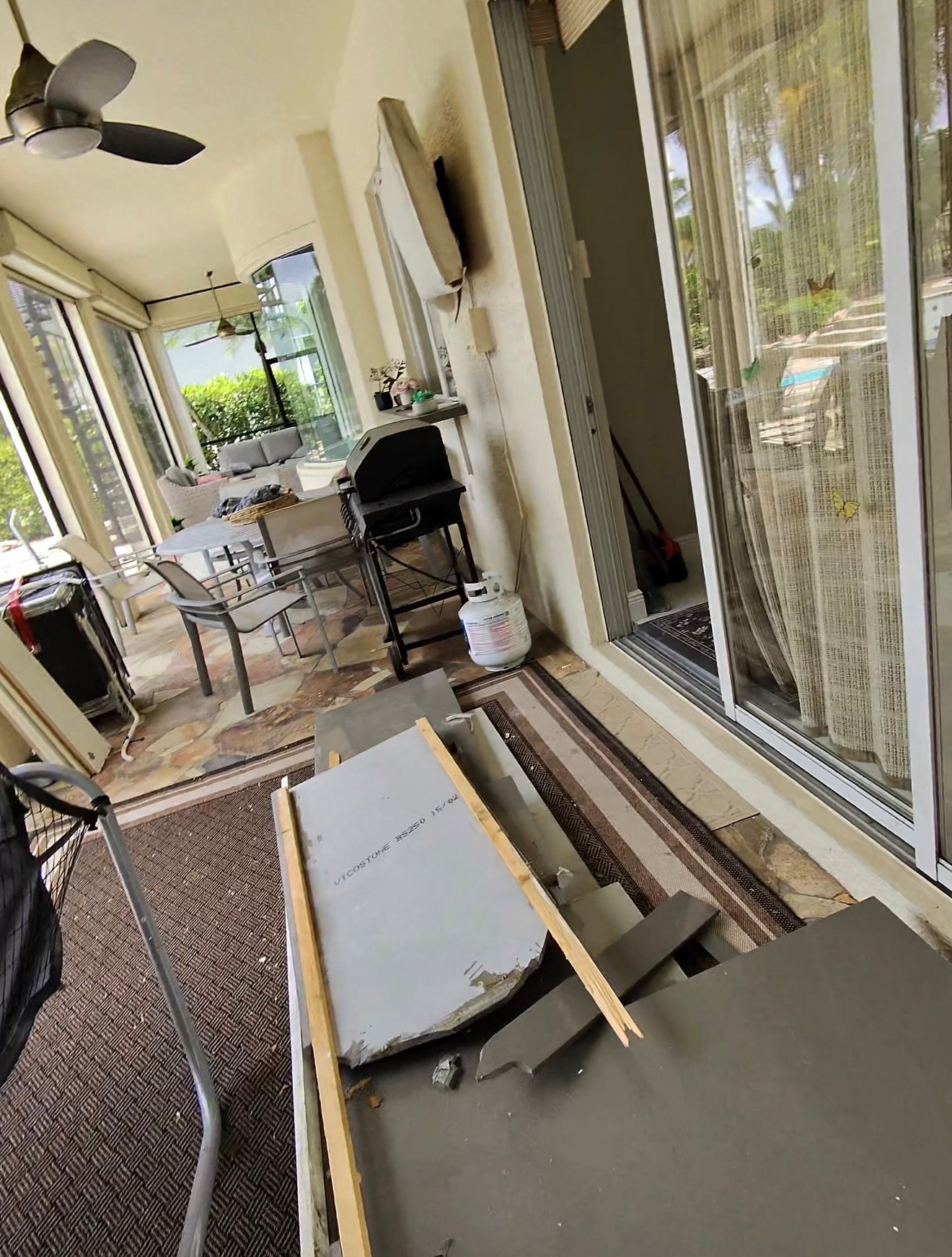 Before — screened patio full of debris and junk